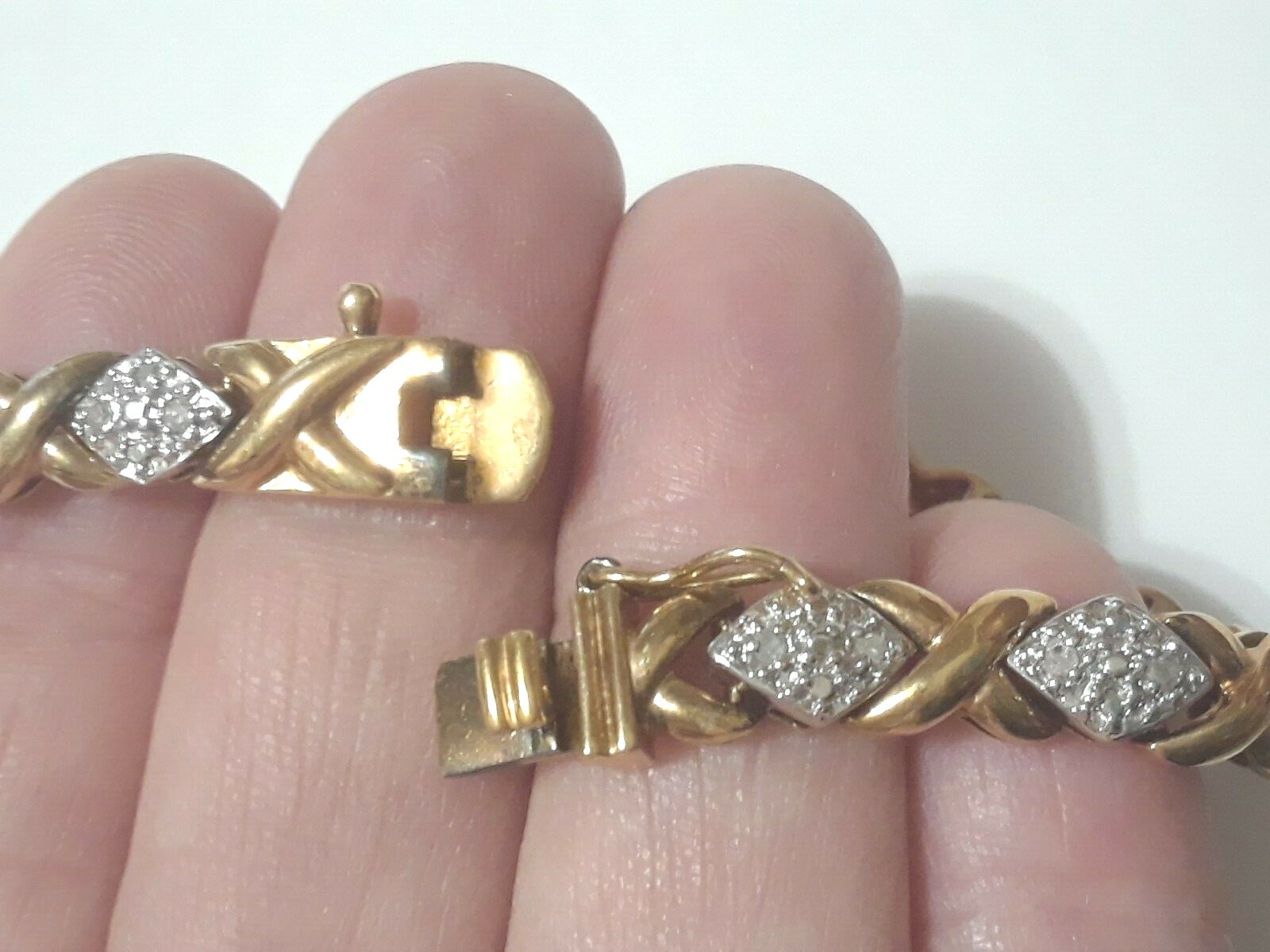 Gold tone bracelet with clear stones and safety lock clasp. 7″ long. Beautiful!