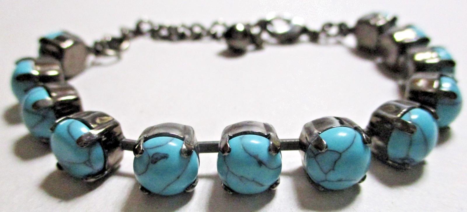 TURQUOISE BLUE HOWLITE BEADED BRACELET IN BLACK GUN METAL