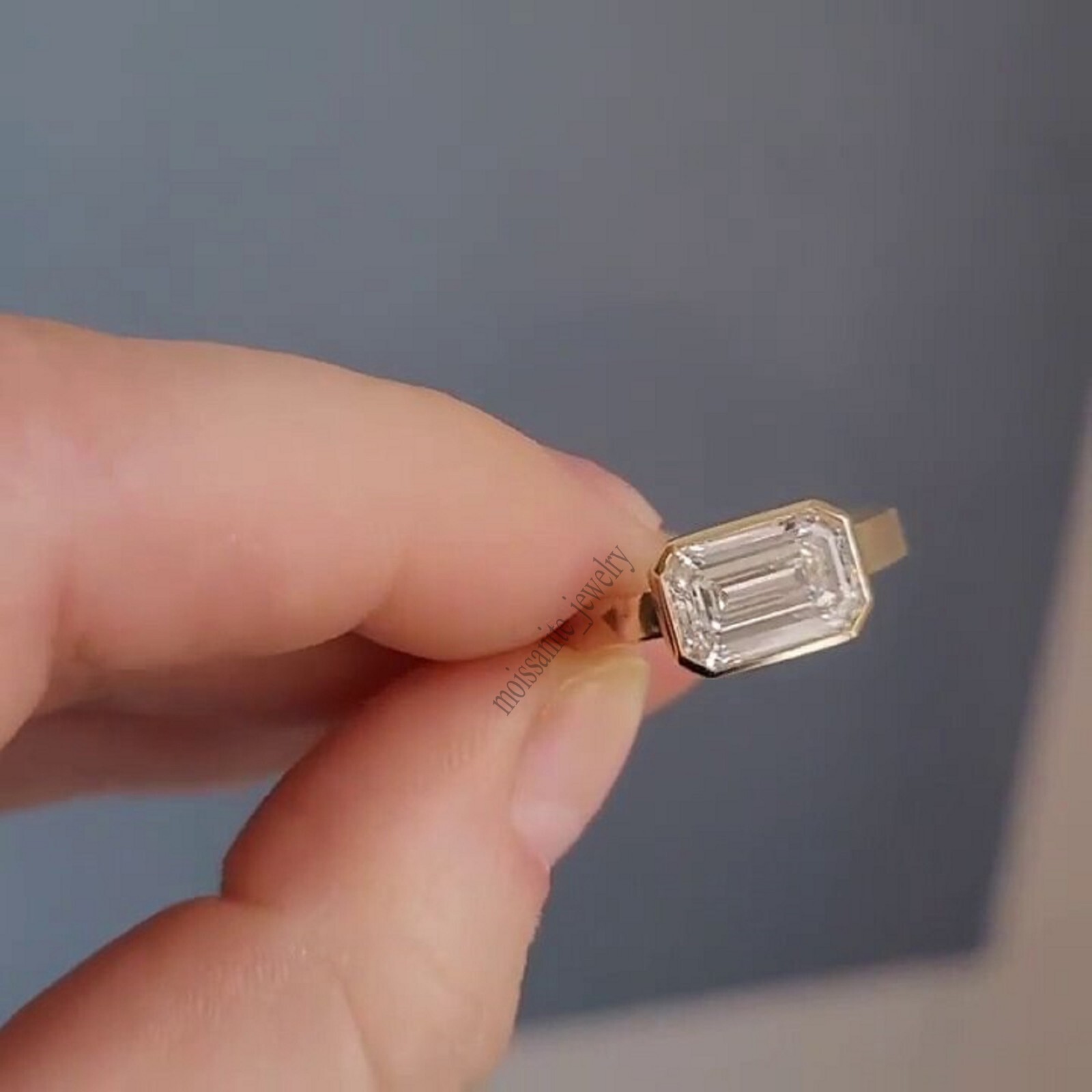 East West Bezel Set 1.70 Carat Emerald Cut White Moissanite Ring 10k Yellow Gold