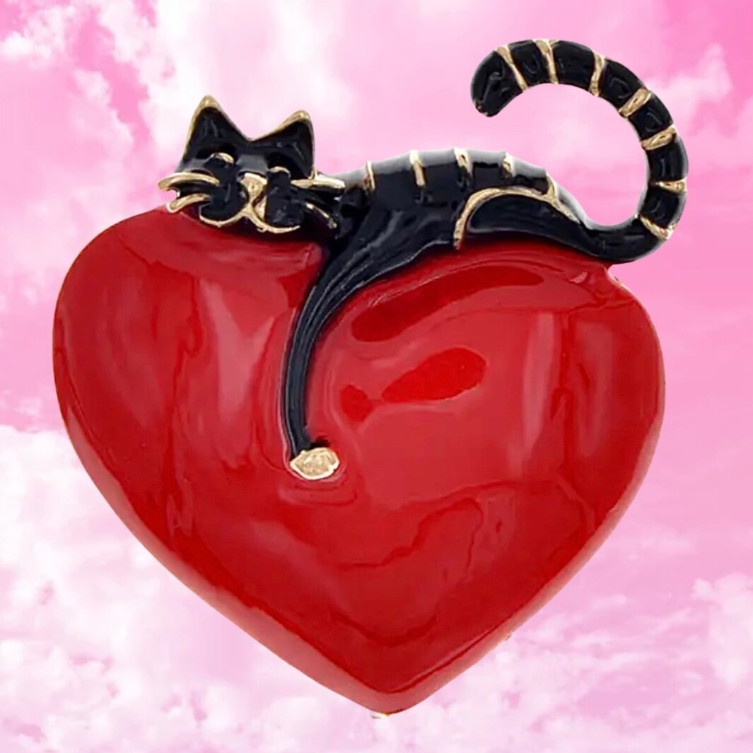 Rich red, shiny heart with comfy cat resting on top. Puffed up. Pin, brooch.