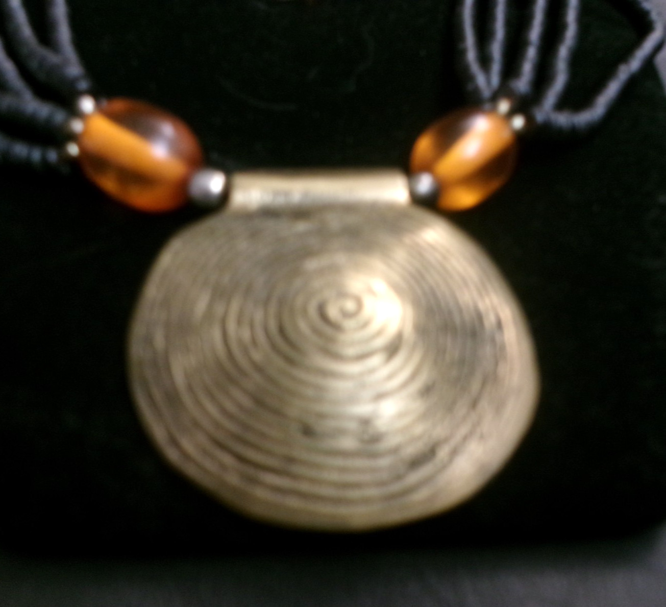 African ethnic tribal necklace features a round pendant brass