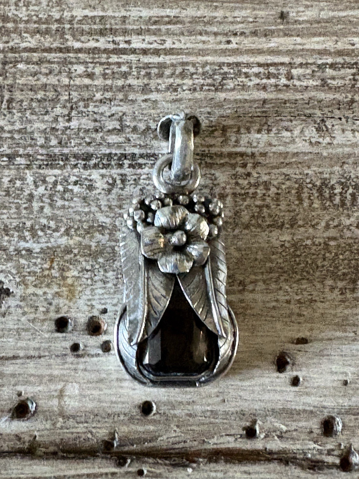 Marked 925 , stone surrounded with silver flower,leaves and berries