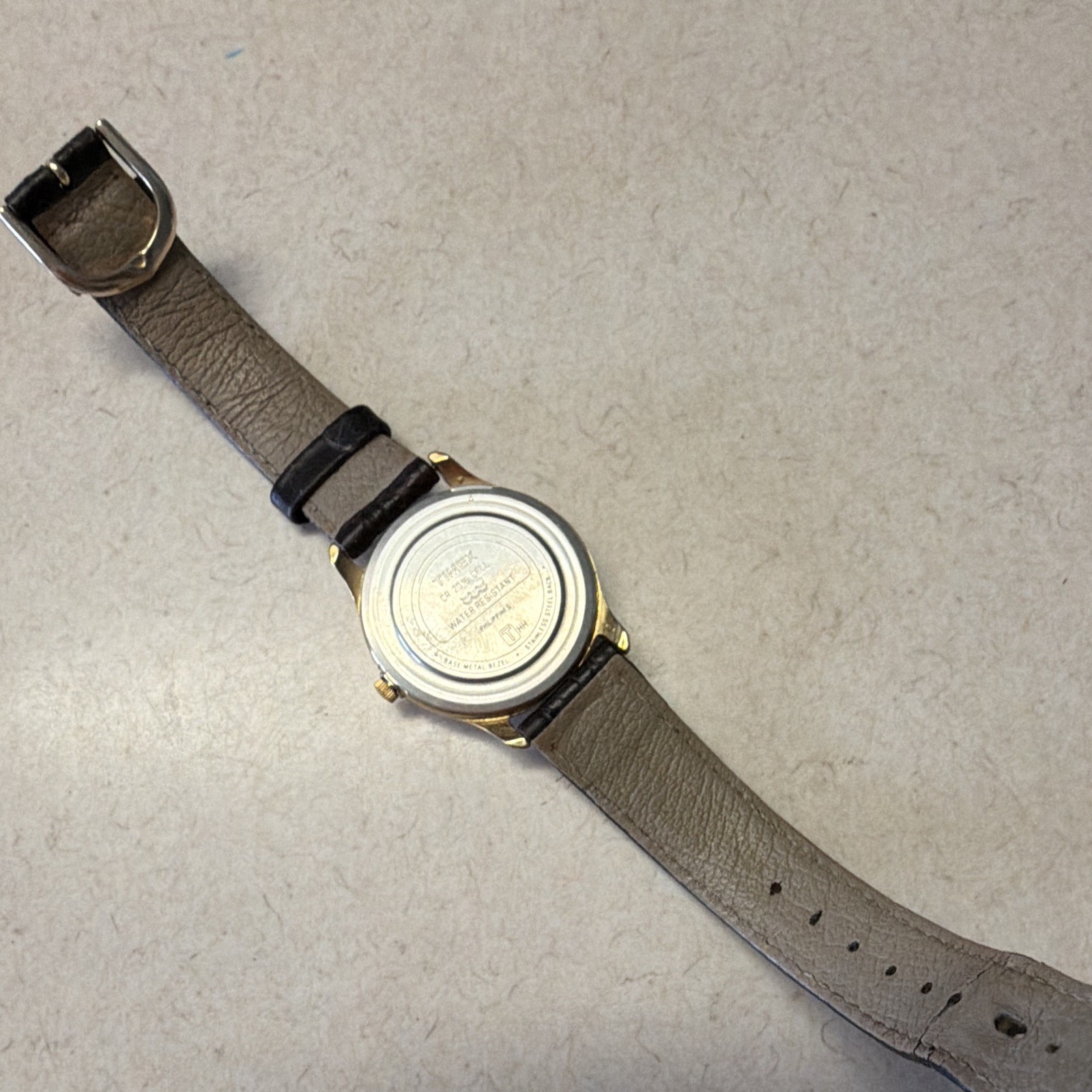 Timex Indiglo Quartz Analog Wristwatch Day/Date 30m Gold Tone Black Leather
