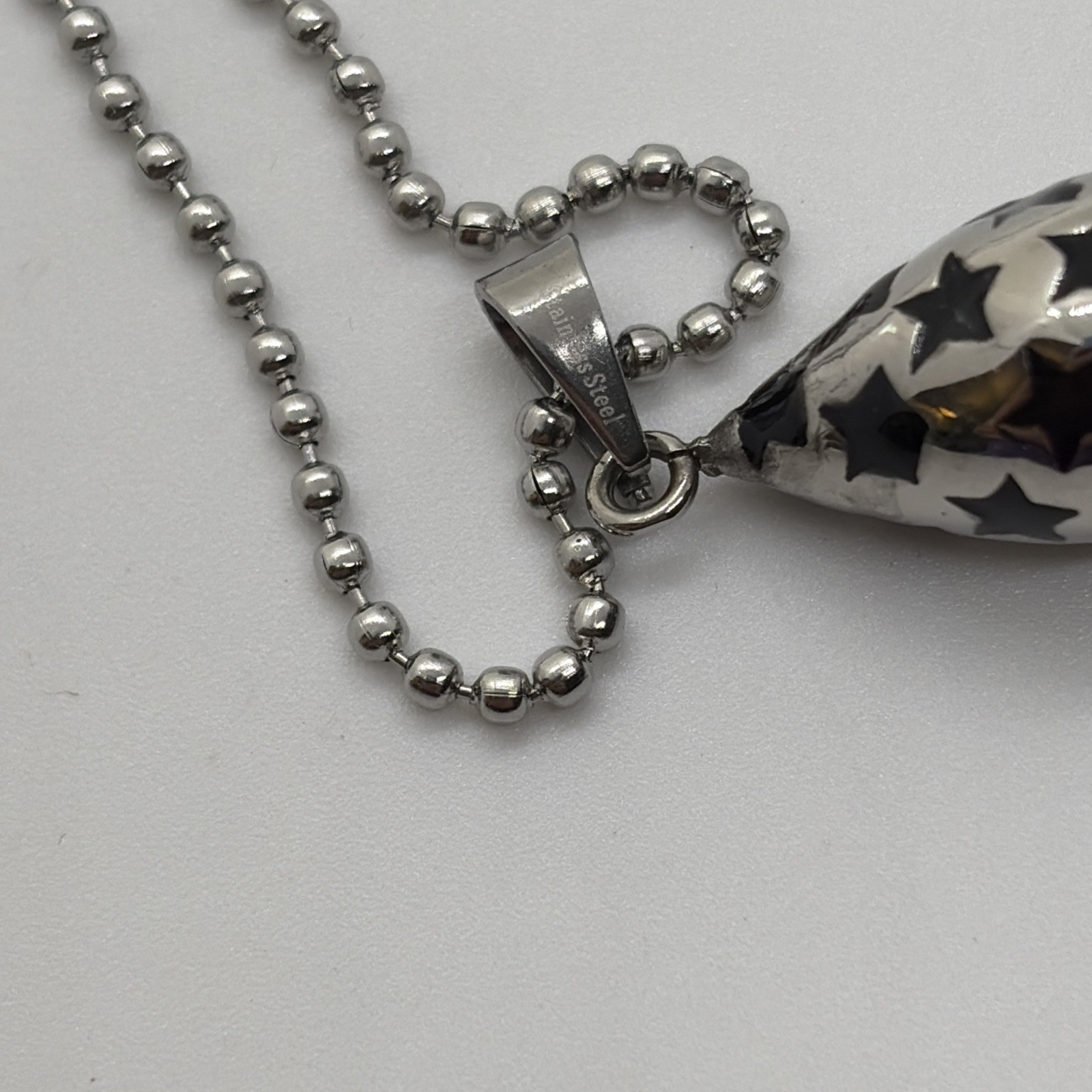 Stainless Steel Pendant With Silver And Black Charm With Stars On A 23” Chain