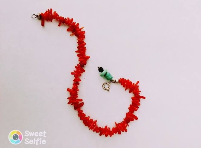 Coral bracelet with a silver clasp closure and a turquoise charm!