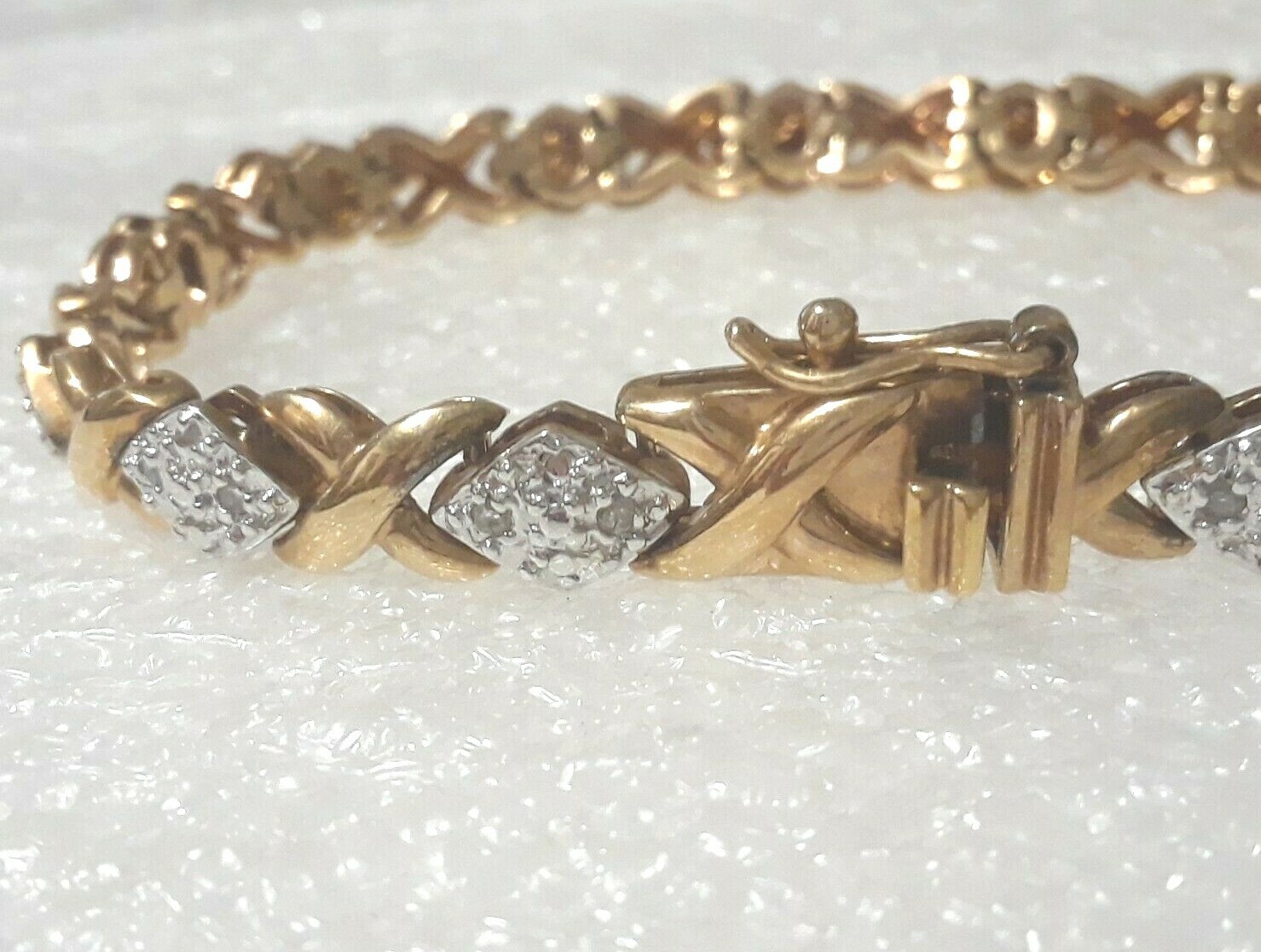 Gold tone bracelet with clear stones and safety lock clasp. 7″ long. Beautiful!