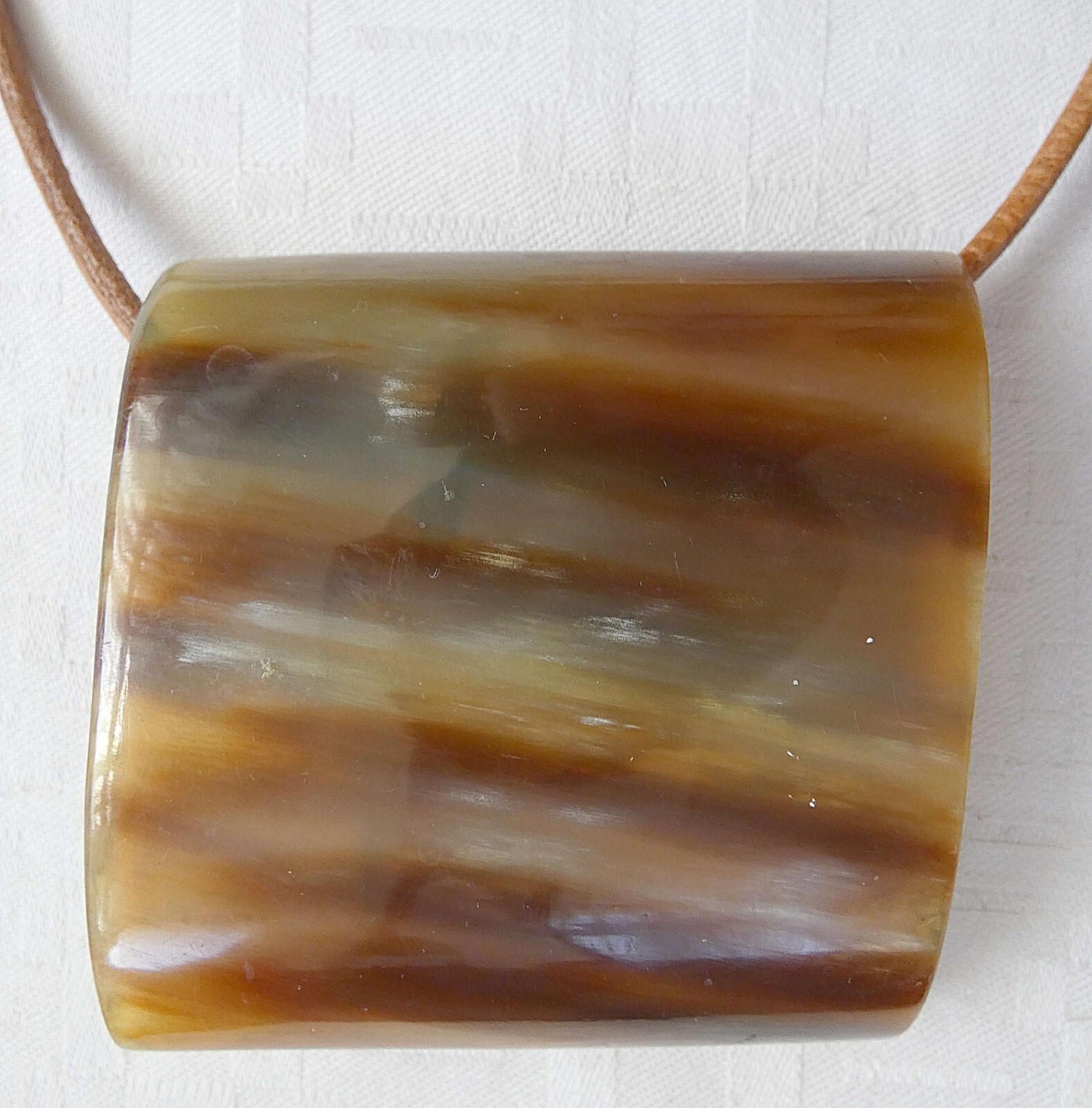 Antique horn necklace with leather cord. Size of pendant: 6.8 x 6.6 cm.