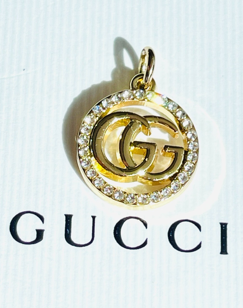 One Gucci Pendant rinestones stamped