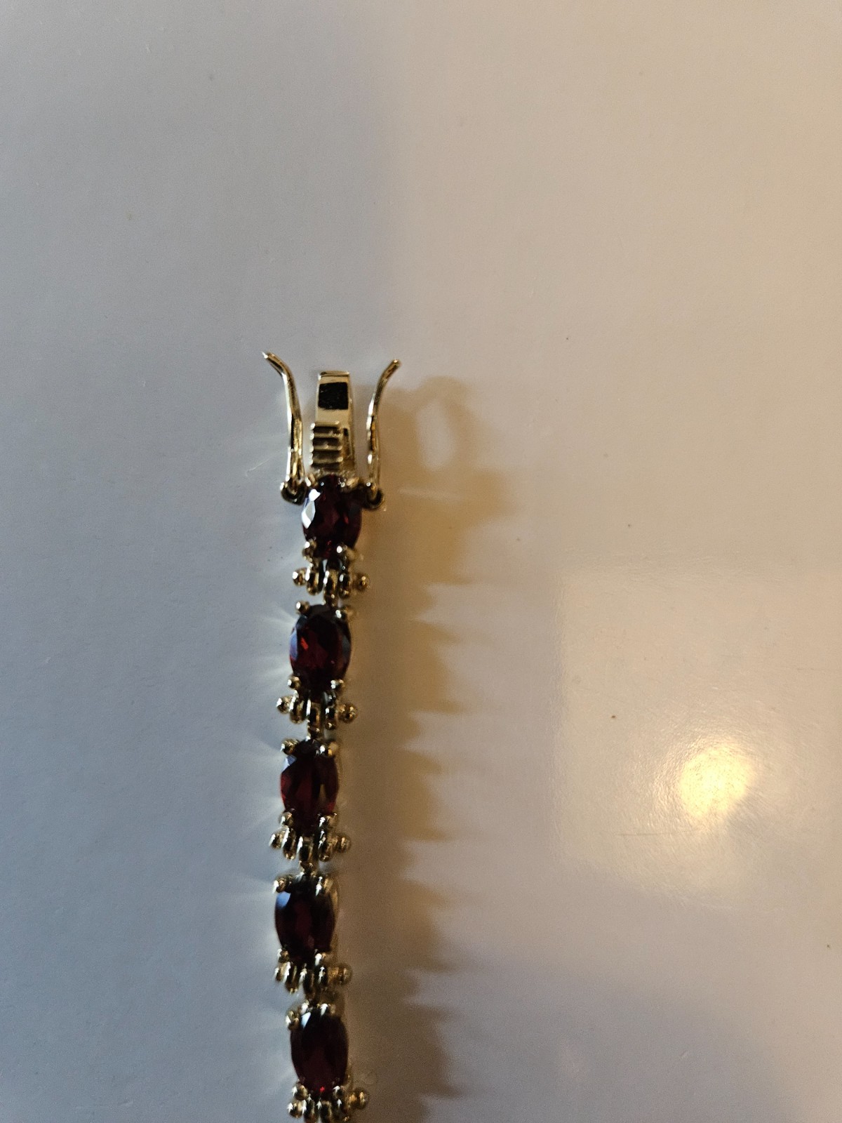 .925 marked with gold tone tourmaline tennis bracelet. Tested by presidium.