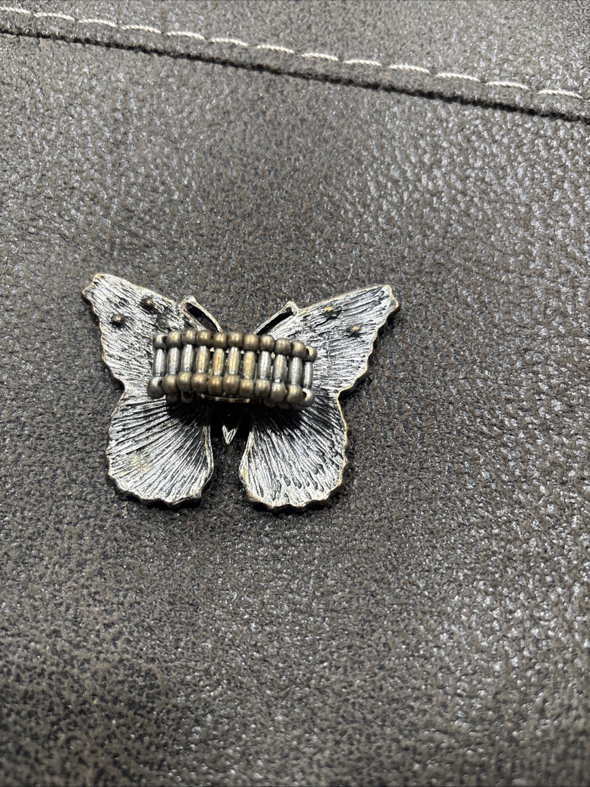 vintage rhinestone butterfly ring featuring a stretchy band design.