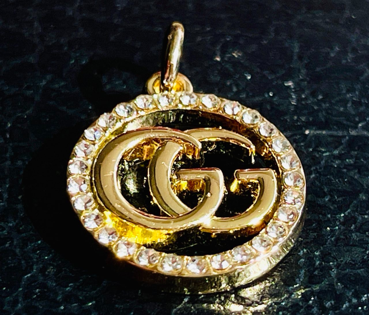 One Gucci Pendant rinestones stamped