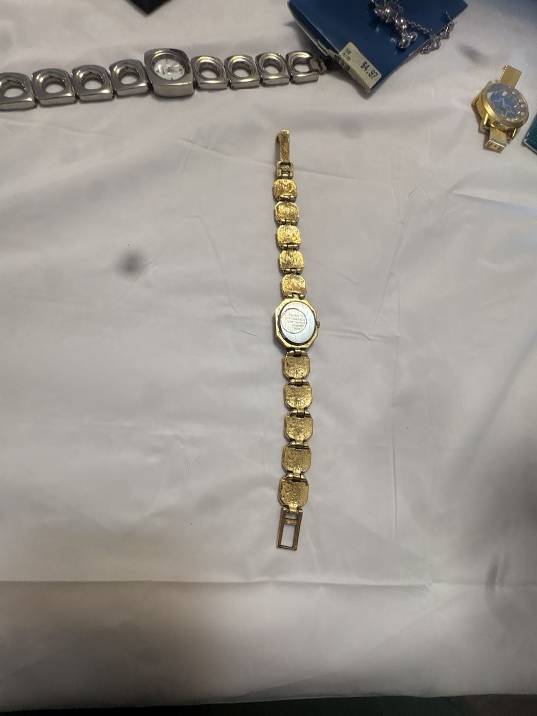 Chico’s Ladies Gold-Tone Crystal Accented Bangle Quartz Watch