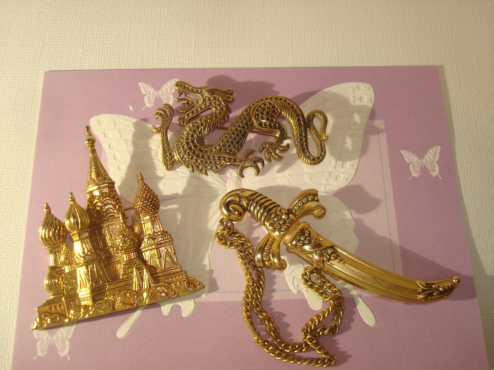 VINTAGE LOT(3) BROOCHES,CHINESE DRAGON,J.J RUSSIAN CATHEDRAL,M/EAST DAGGER PERF.
