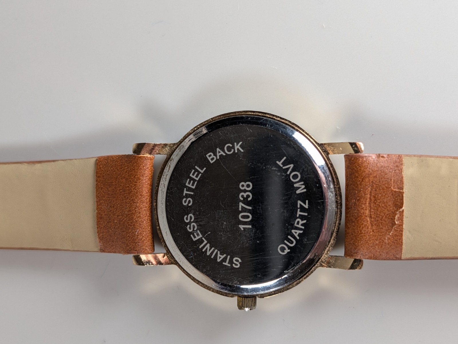 Elephant watch with flower pattern and gold outline and dot indexes brown band