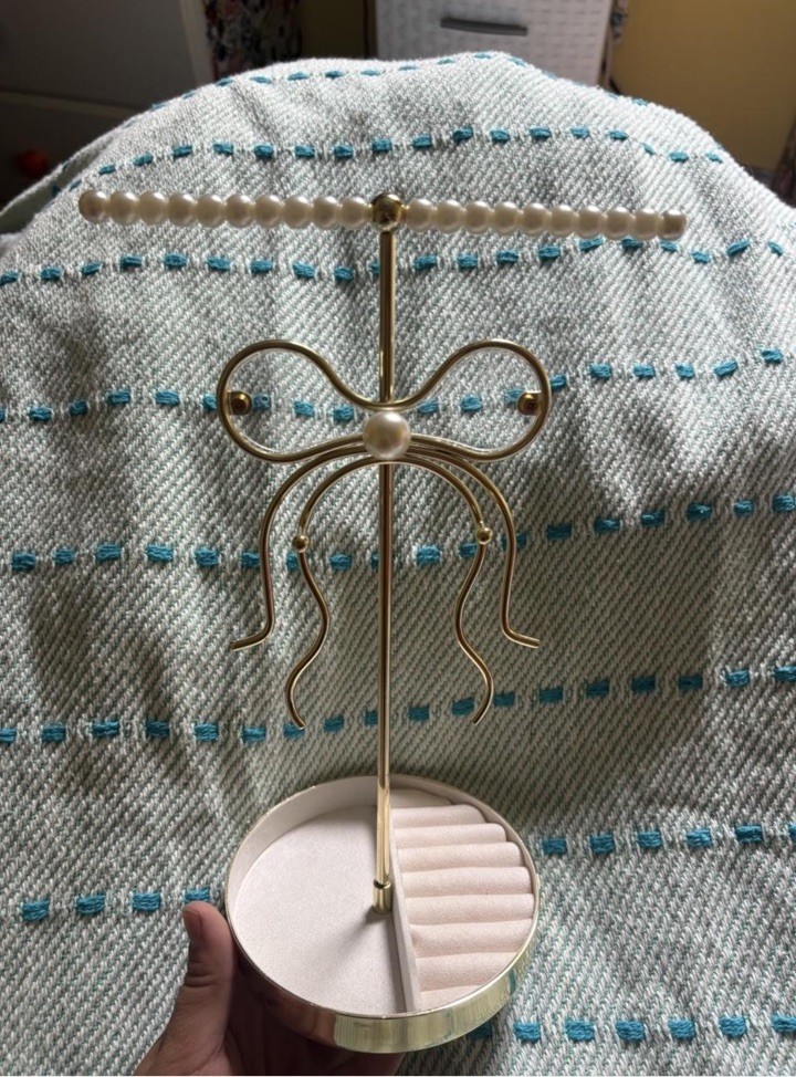 Gold and Pearl Jewelry Holder with a Bow Shape on the Front. Cute For a Jewelry!