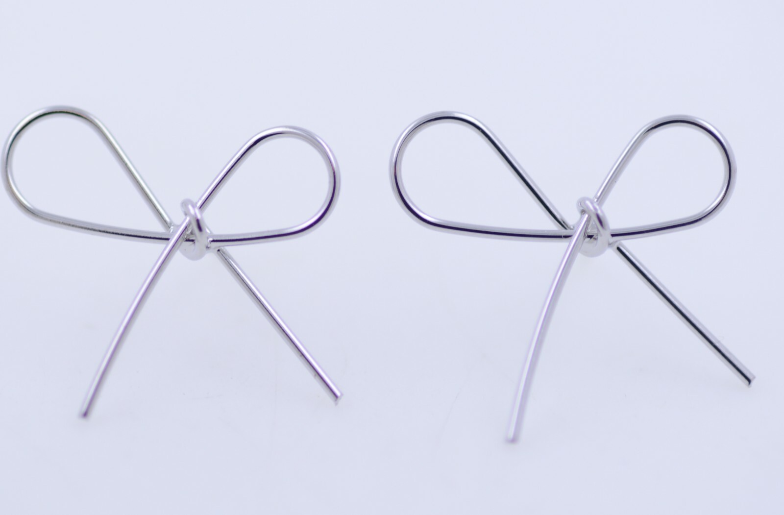 Super cute silver tone alloy cut out bow stud earrings
