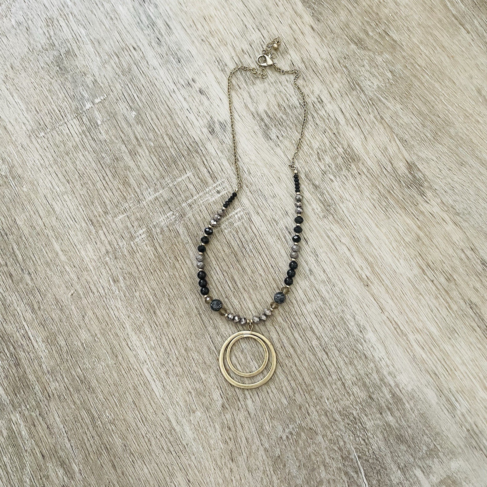 Gold Double Ring Pendant Necklace with Black and Gray Beads
