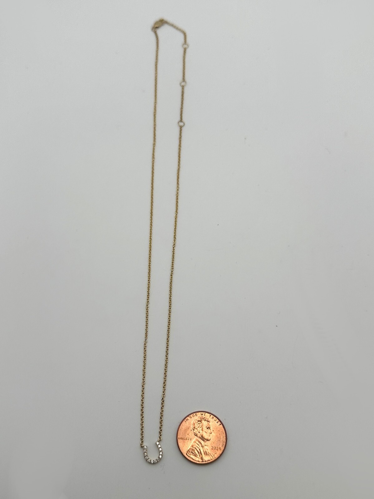 14k Gold 18″ Necklace, Horseshoe center piece set with 0.08cts of Diamonds 2g