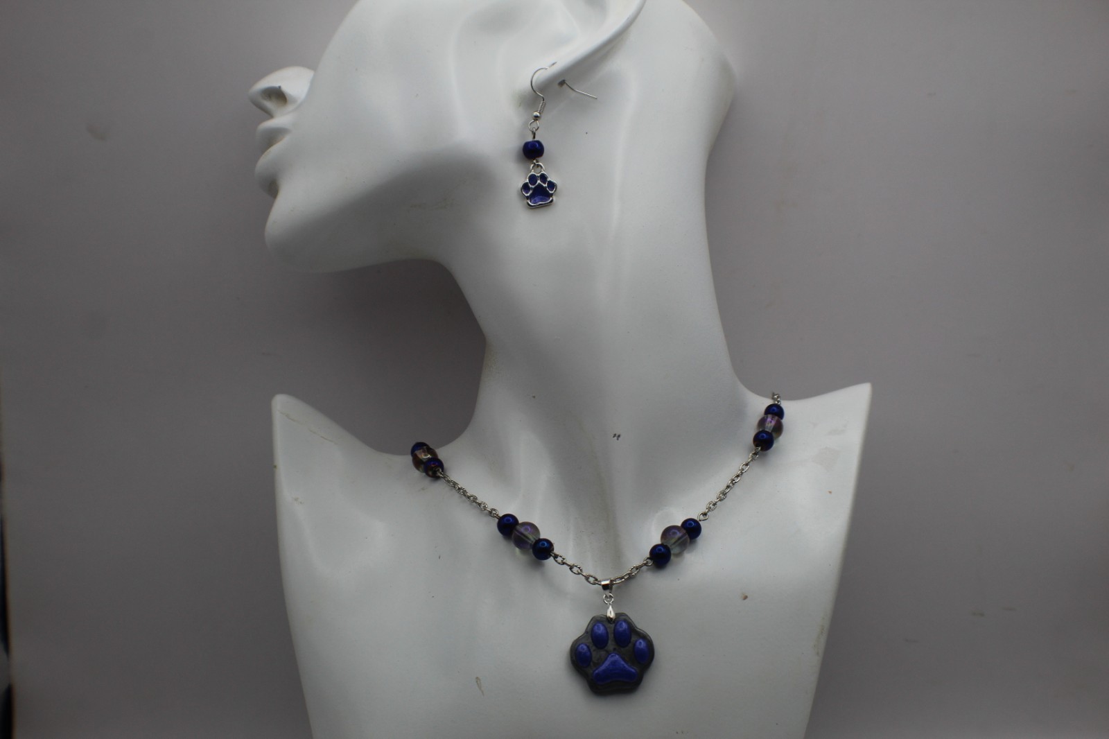 Cute Purple Paw Print Resin Pendant On A Beard Chain Necklace.