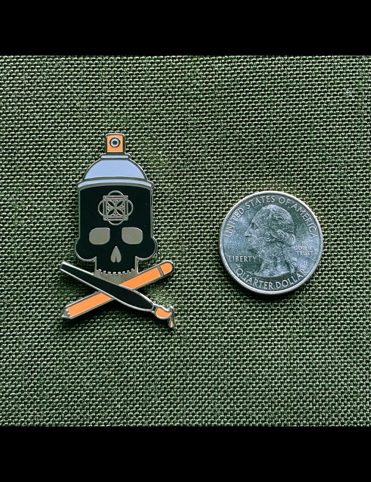 Crossbrushes 1.25″ black orange grey nickel enamel pin with single clasp