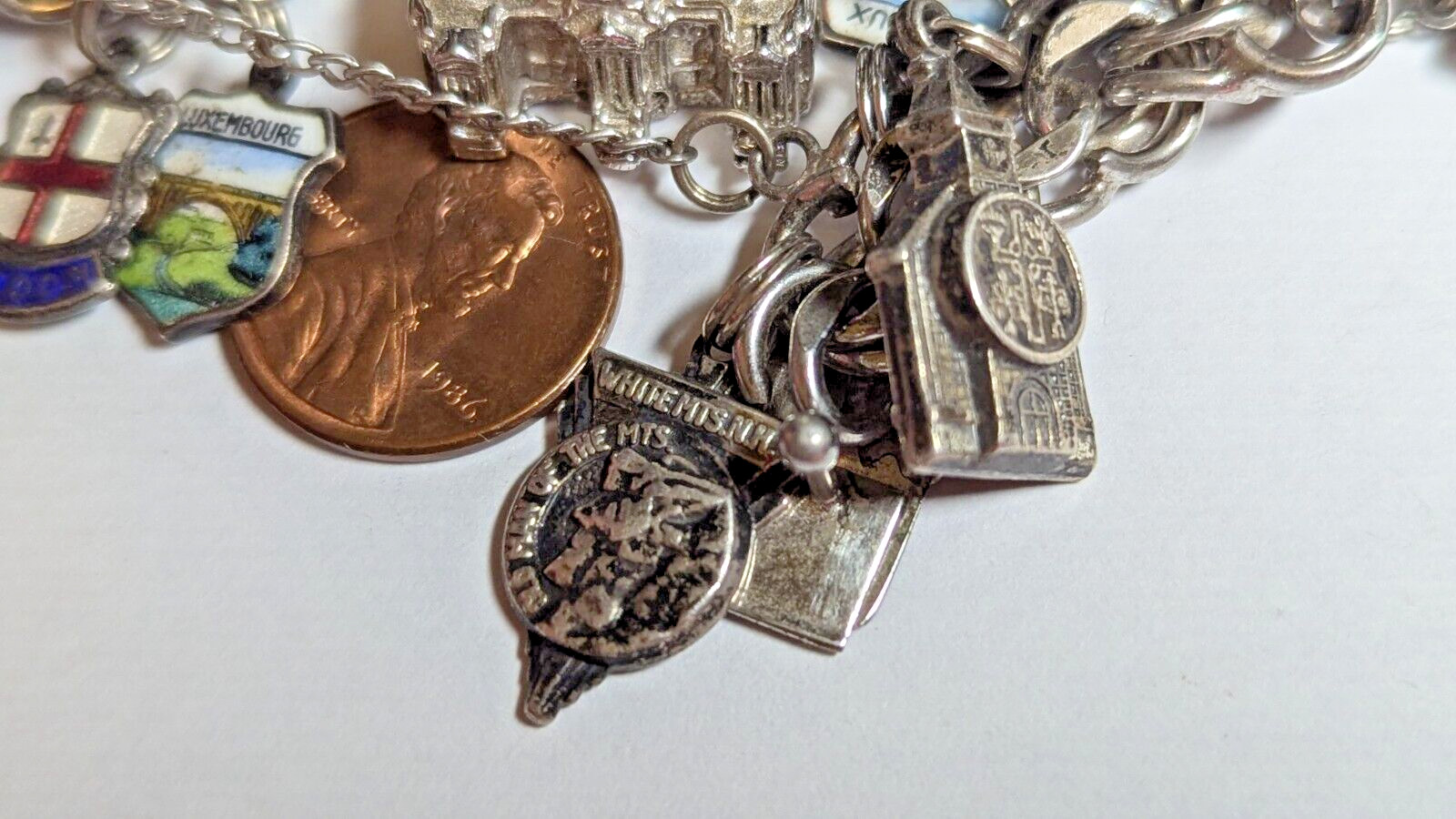 VINTAGE STERLING SILVER CHARM BRACELET WITH ABOUT 35 CHARMS WEIGHS 94.4 GRAMS