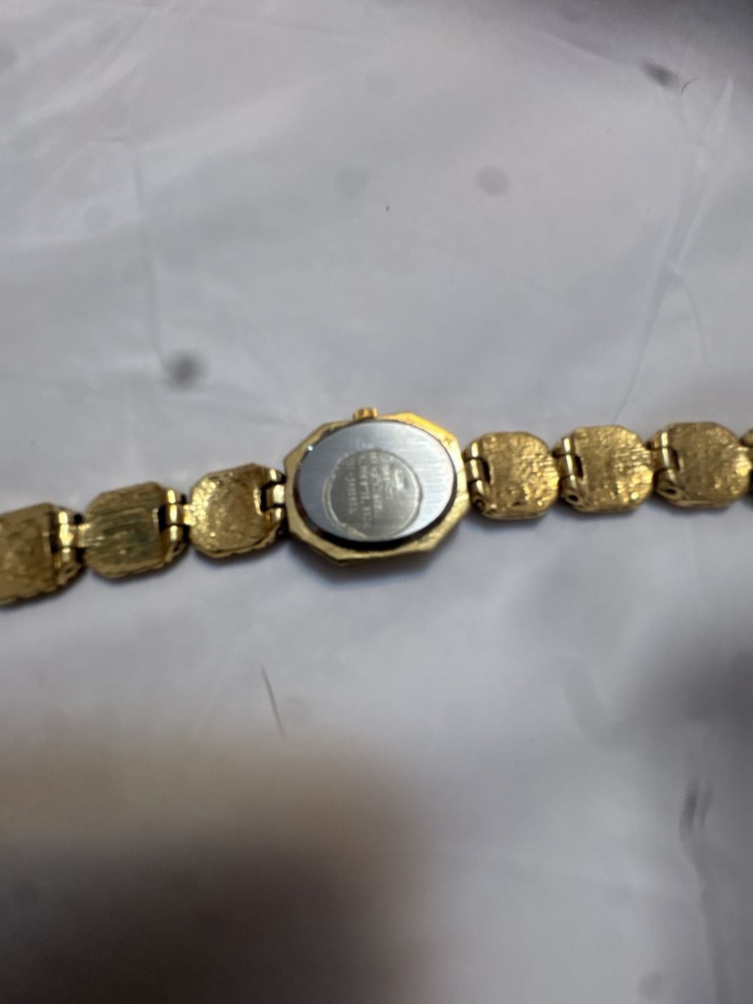 Chico’s Ladies Gold-Tone Crystal Accented Bangle Quartz Watch