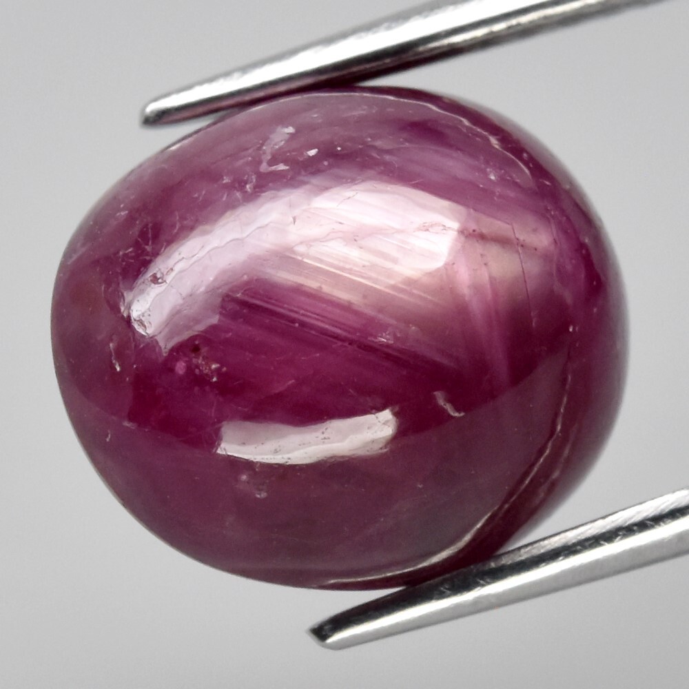 9.05ct 12×9.8mm Oval Cab Purplish Red 6 Ray Star Ruby (Heated Glass Filling)