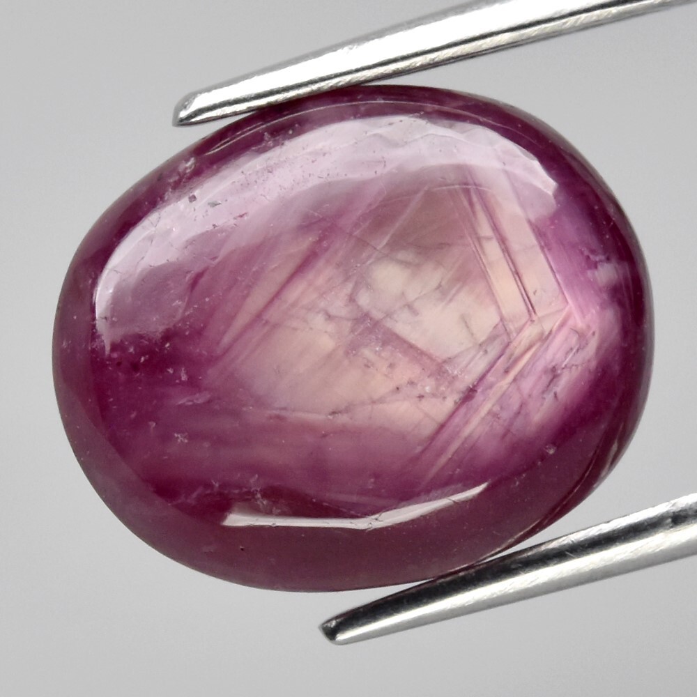 9.05ct 12×9.8mm Oval Cab Purplish Red 6 Ray Star Ruby (Heated Glass Filling)