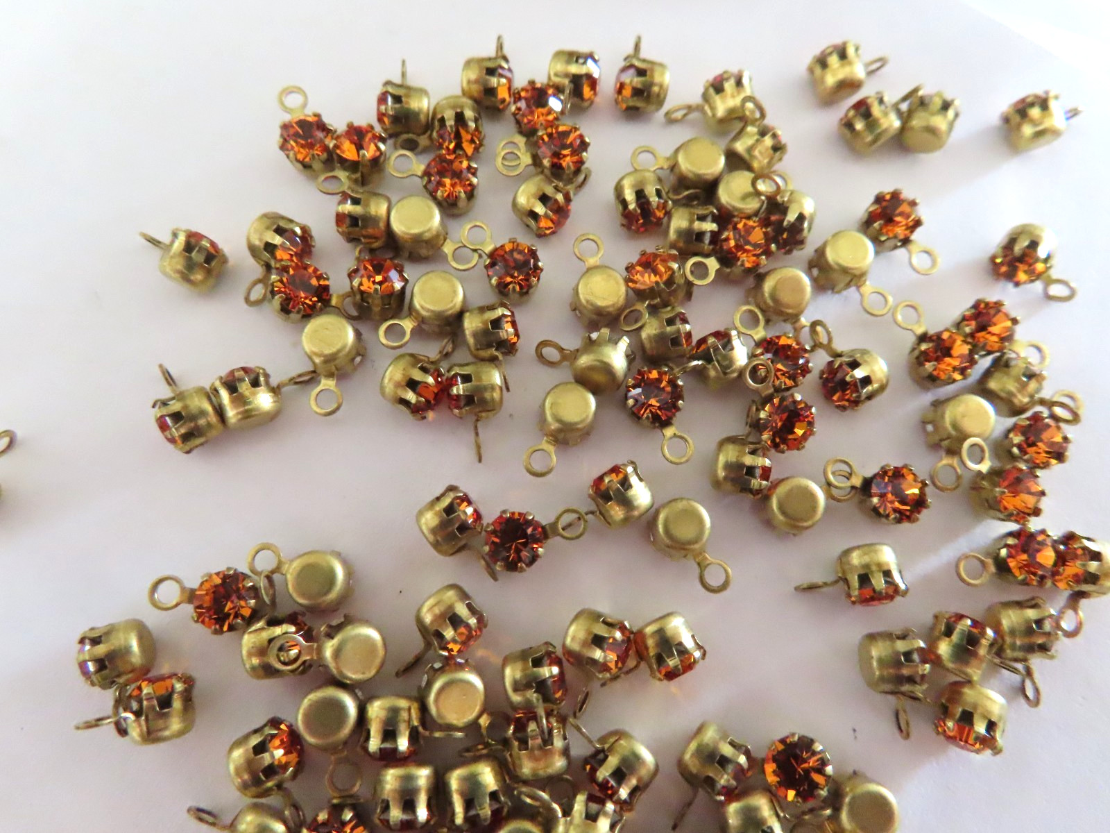 72 Swarovski Rhinestones 32pp Topaz/ 1-loop brass tiffany settings.
