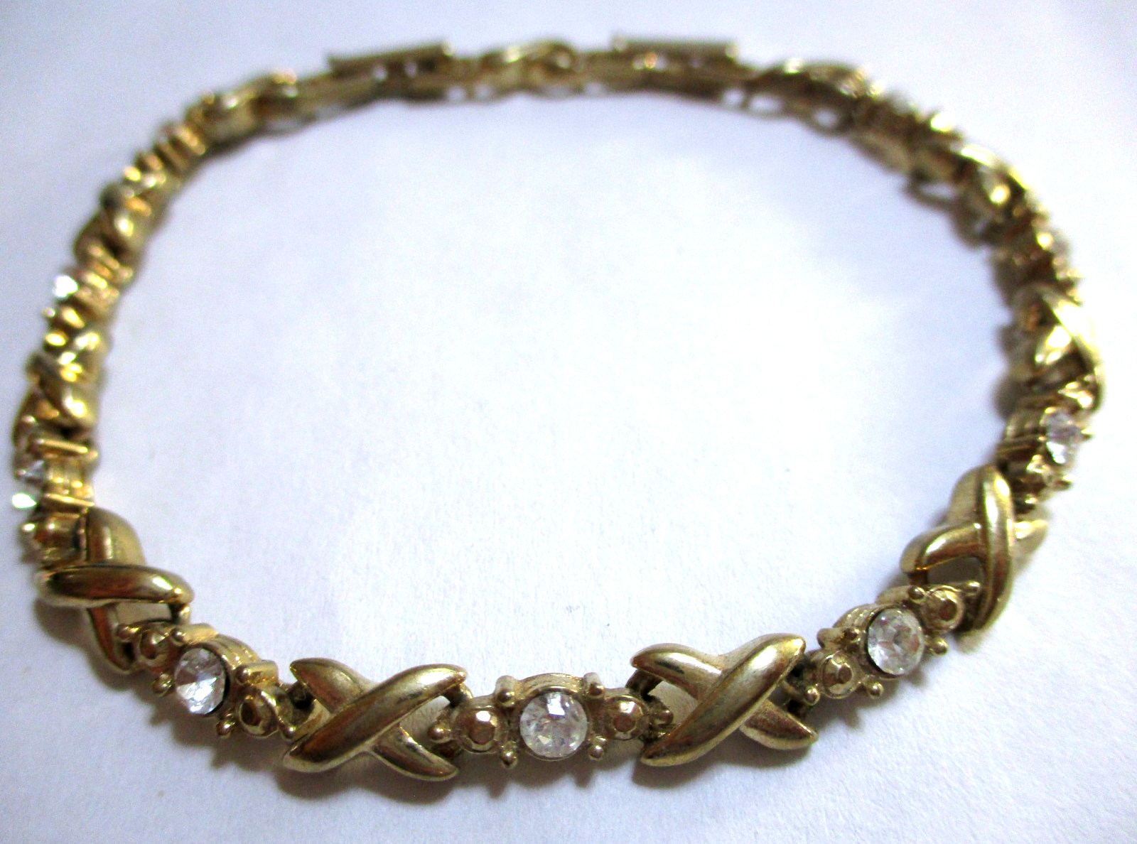 VINTAGE SIGNED AVON RHINESTONE TENNIS BRACELET X’S & O’S, GOLDTONE