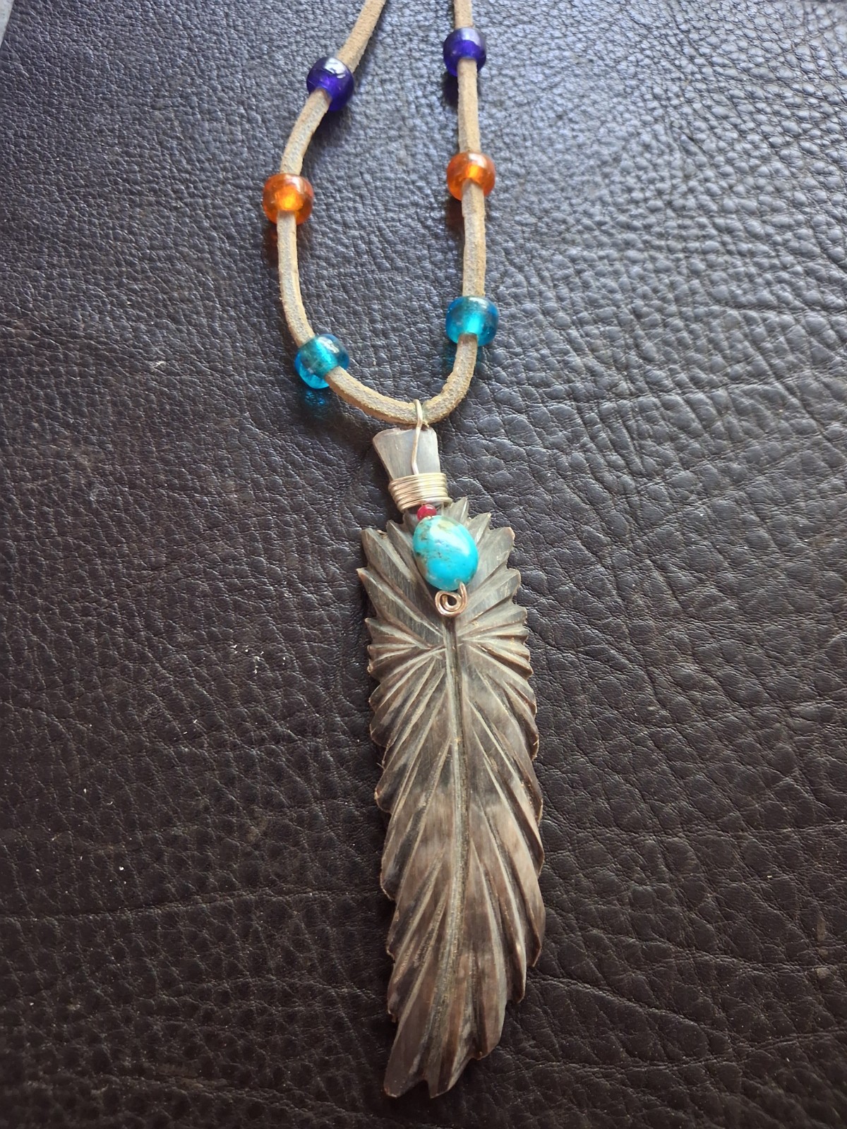 hand carved feather (from horn) pendants