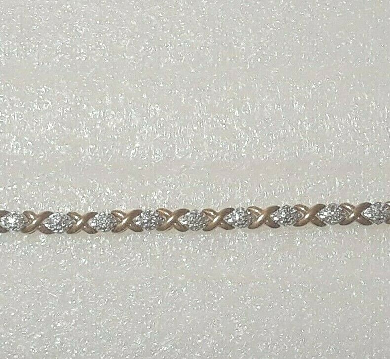 Gold tone bracelet with clear stones and safety lock clasp. 7″ long. Beautiful!