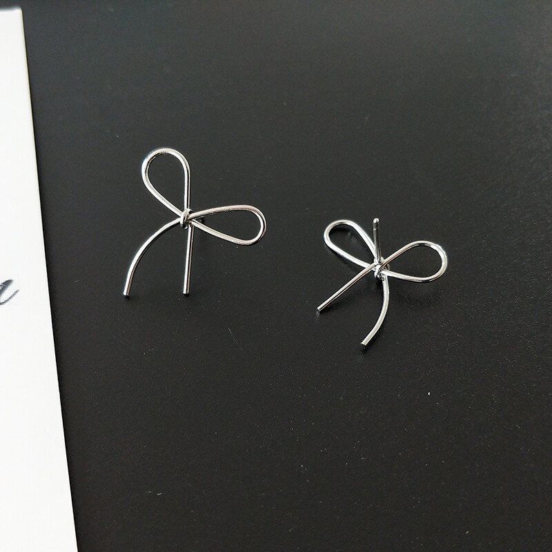 Super cute silver tone alloy cut out bow stud earrings