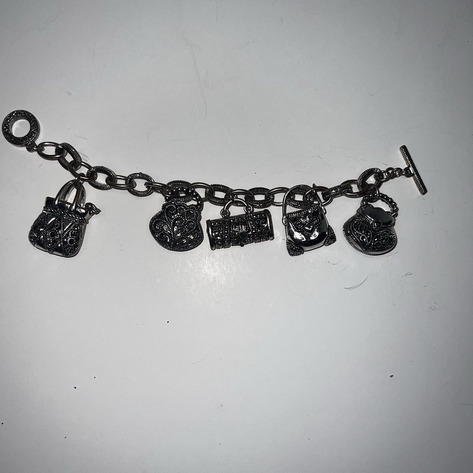 Silver-Tone Metal Puffy Openwork Purse Rhinestone Accent Charm Bracelet toggle