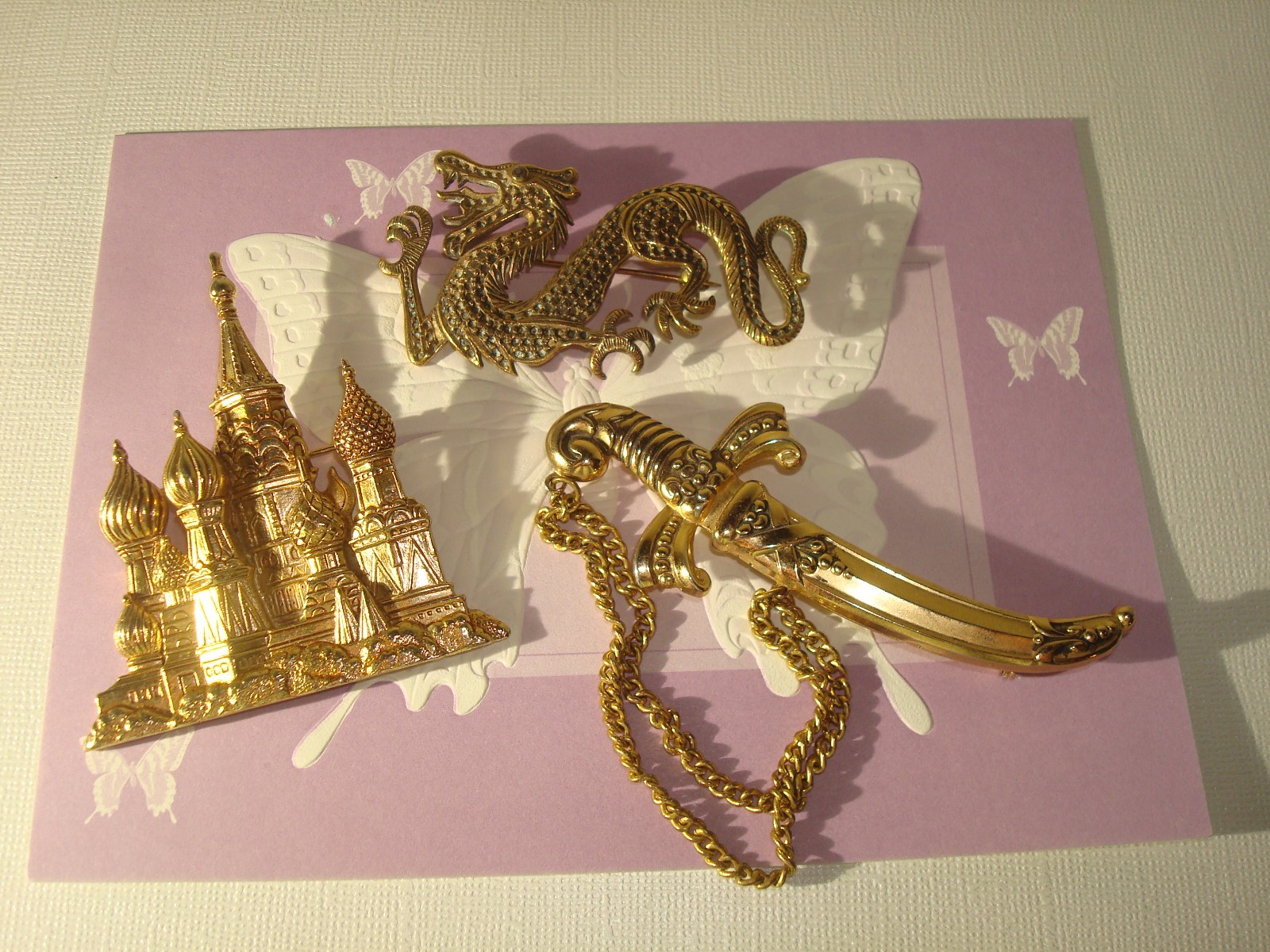 VINTAGE LOT(3) BROOCHES,CHINESE DRAGON,J.J RUSSIAN CATHEDRAL,M/EAST DAGGER PERF.