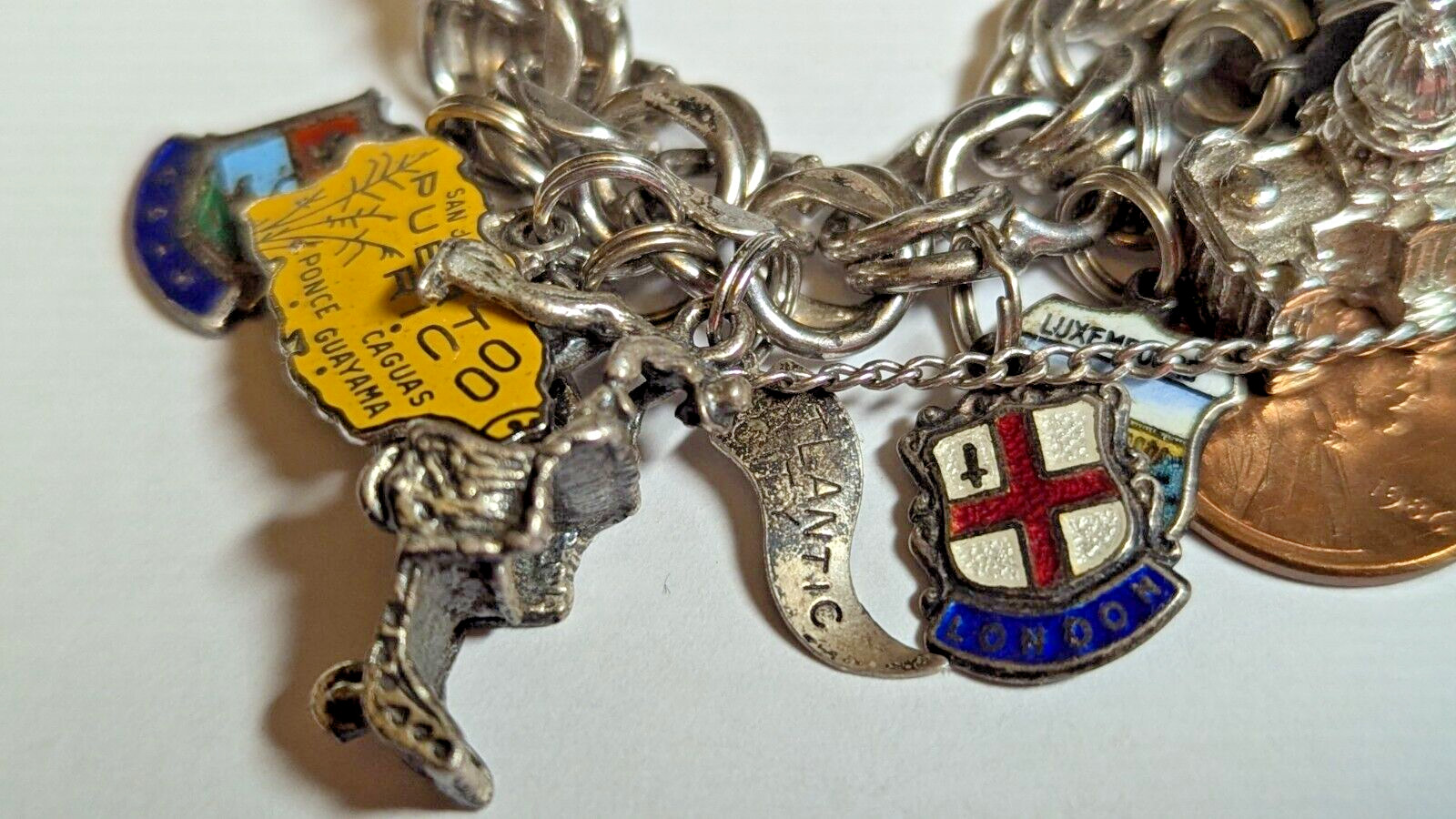 VINTAGE STERLING SILVER CHARM BRACELET WITH ABOUT 35 CHARMS WEIGHS 94.4 GRAMS