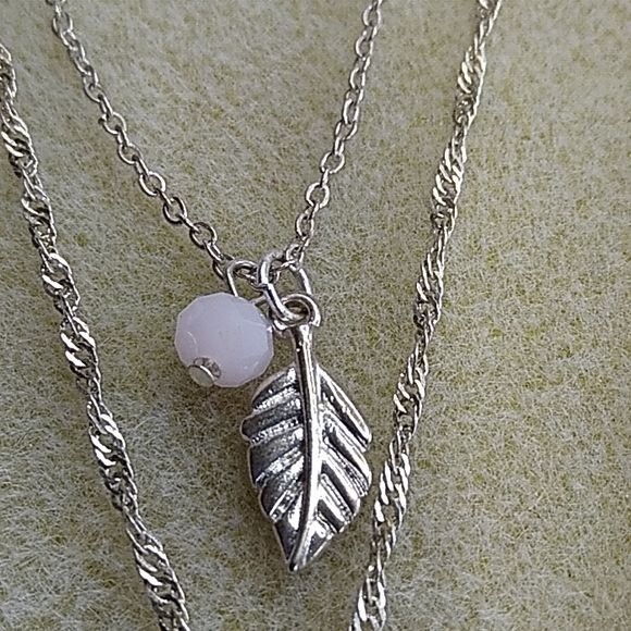 Claire’s silvertone multi-strand necklace with pink flower pendant