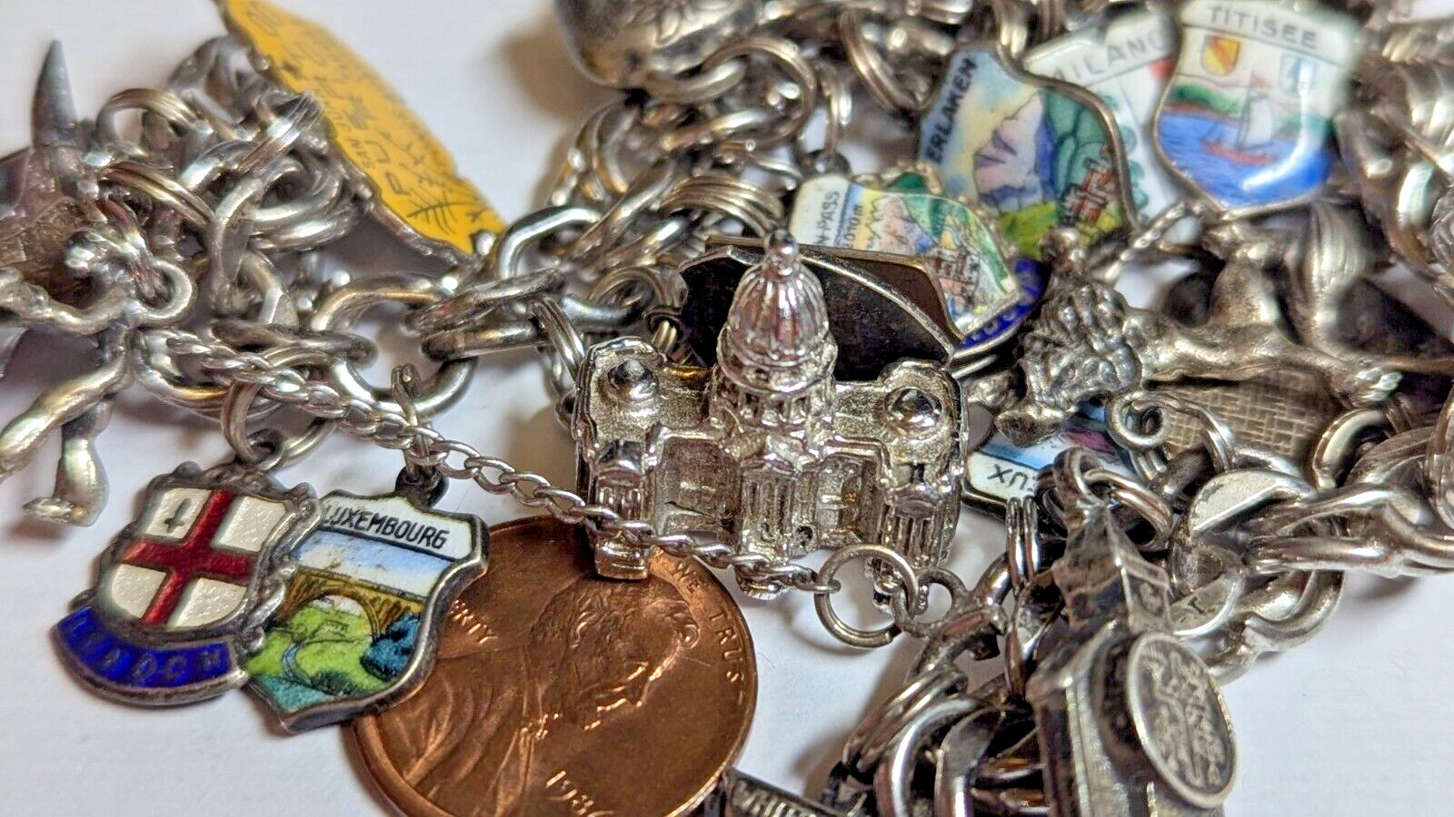 VINTAGE STERLING SILVER CHARM BRACELET WITH ABOUT 35 CHARMS WEIGHS 94.4 GRAMS