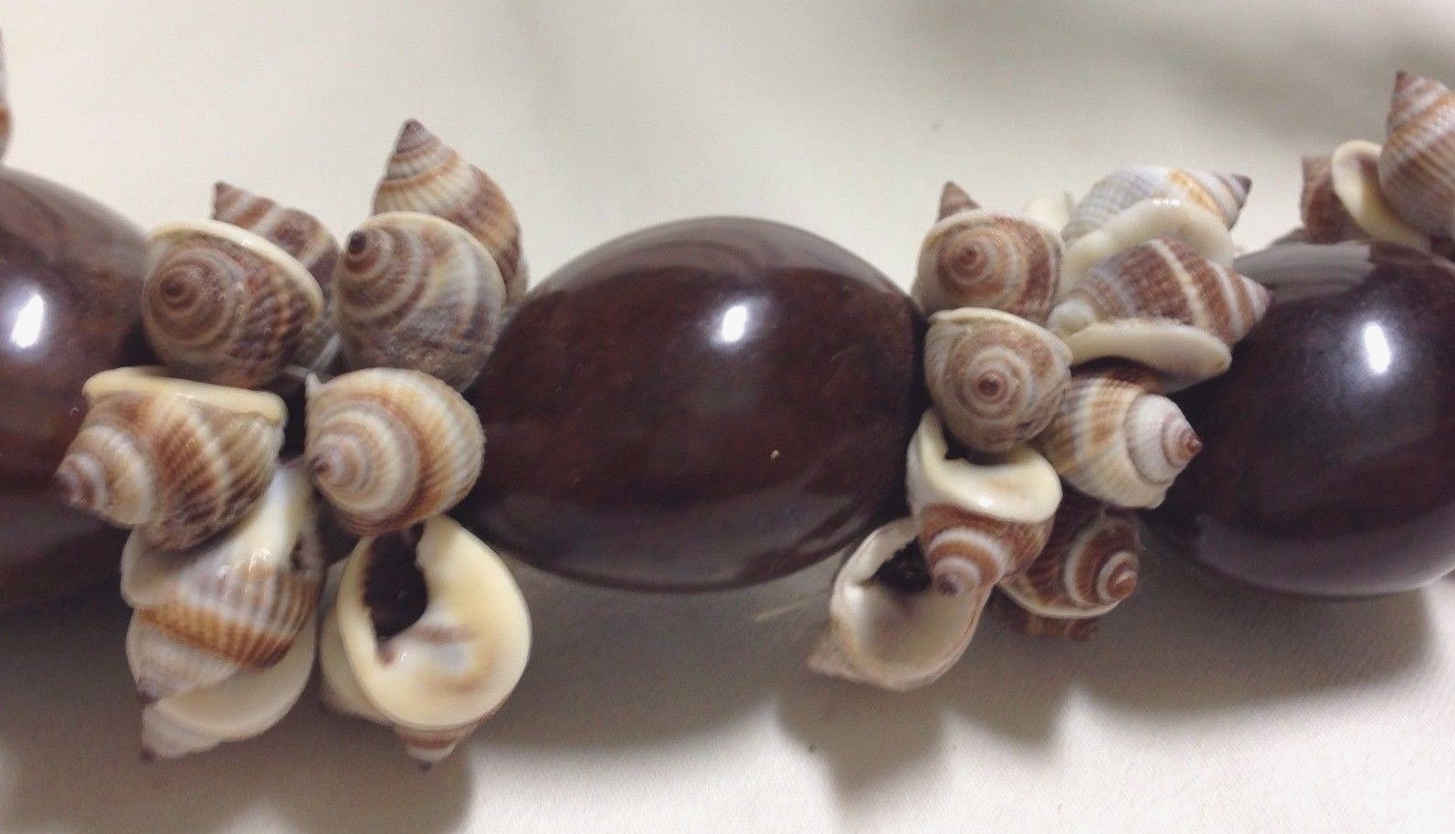 24-28-inch Kukui Nut/Seed & Nassa Shell Lei with Brown Ribbon, Adjustable