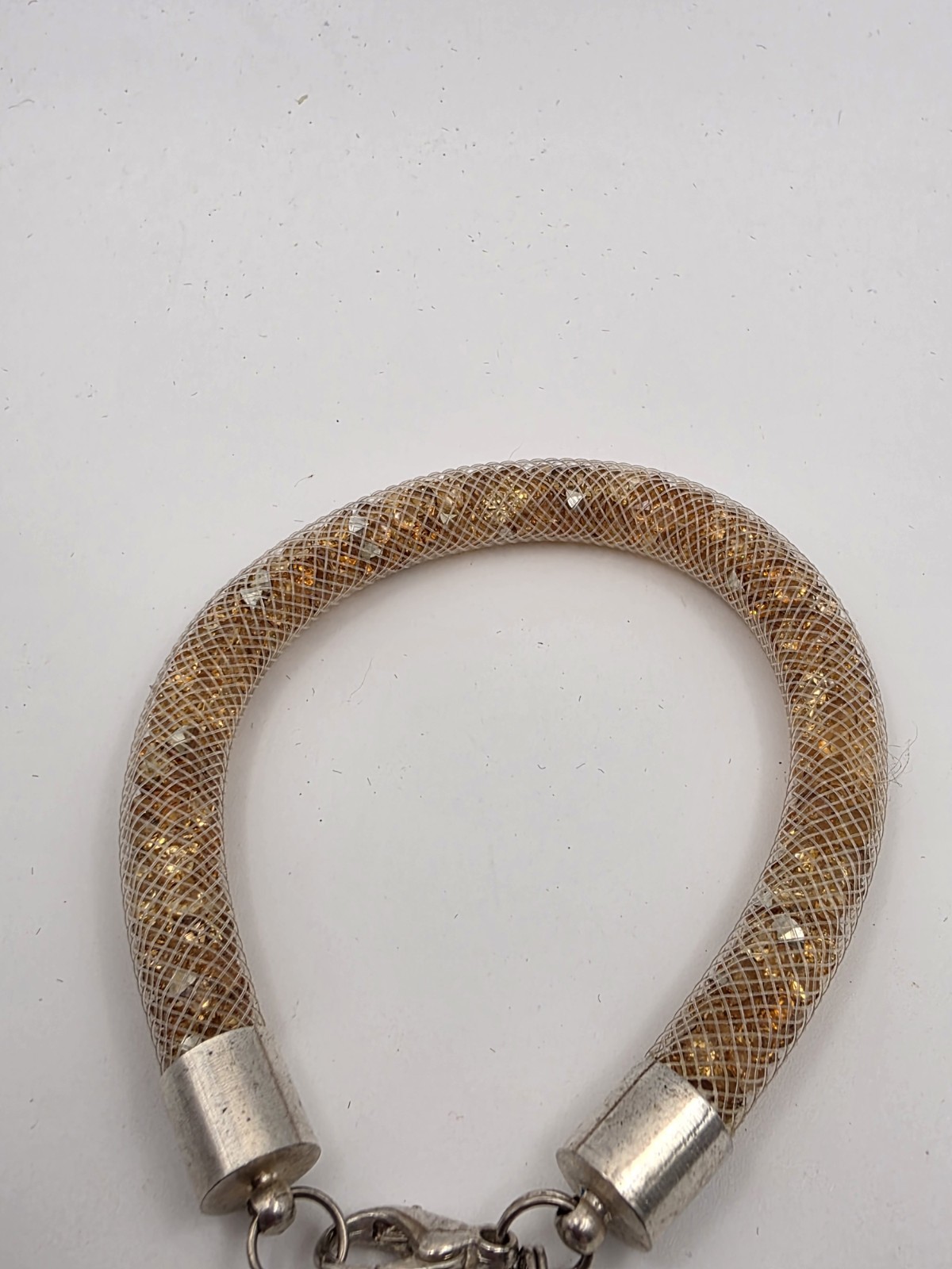 Gold Tone Tubular Mesh Bangle With Crystals And Heart Charm