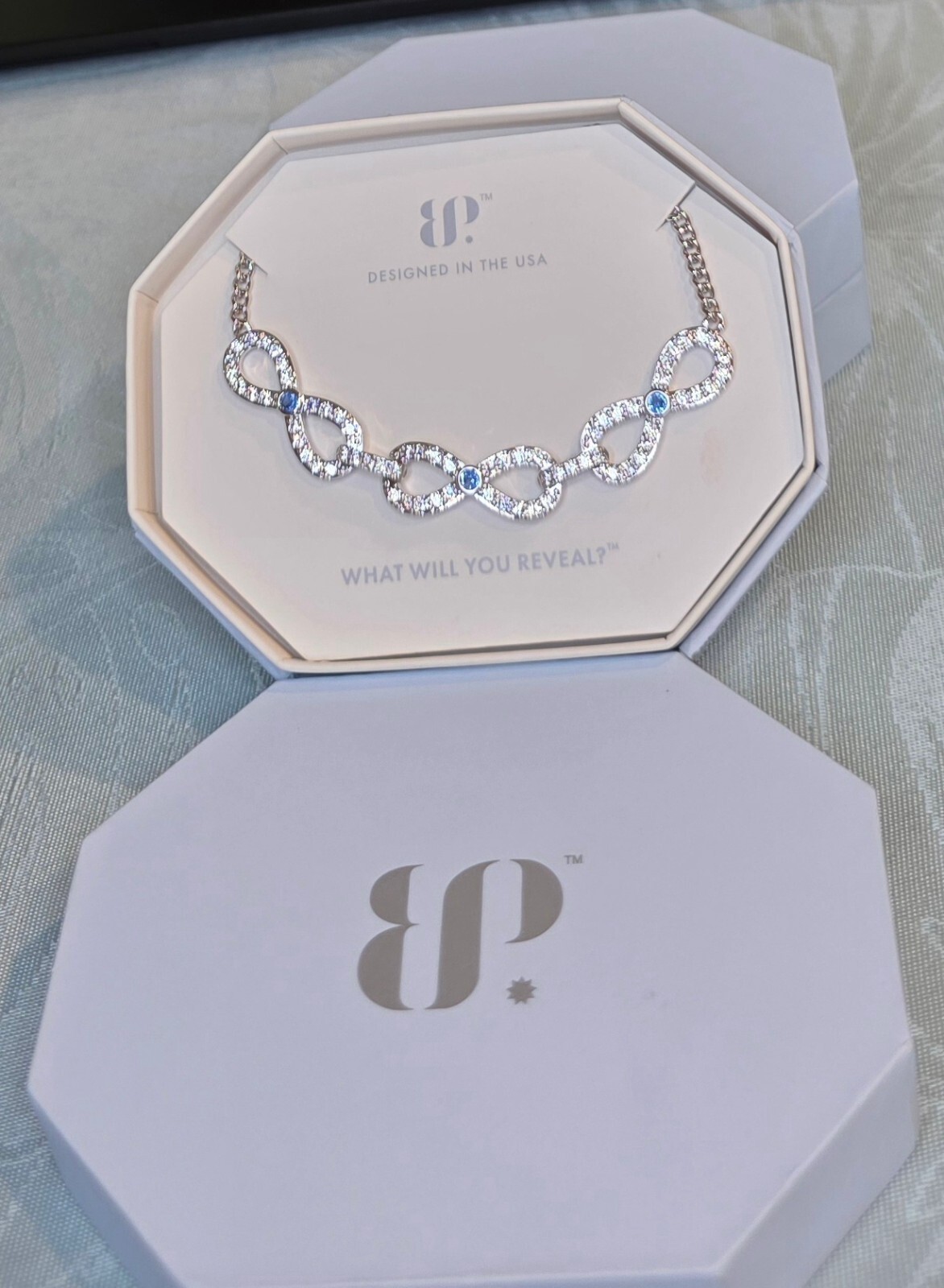 BP Infinity Bound Rhodium Plated Necklace with Aqua Blue Lab