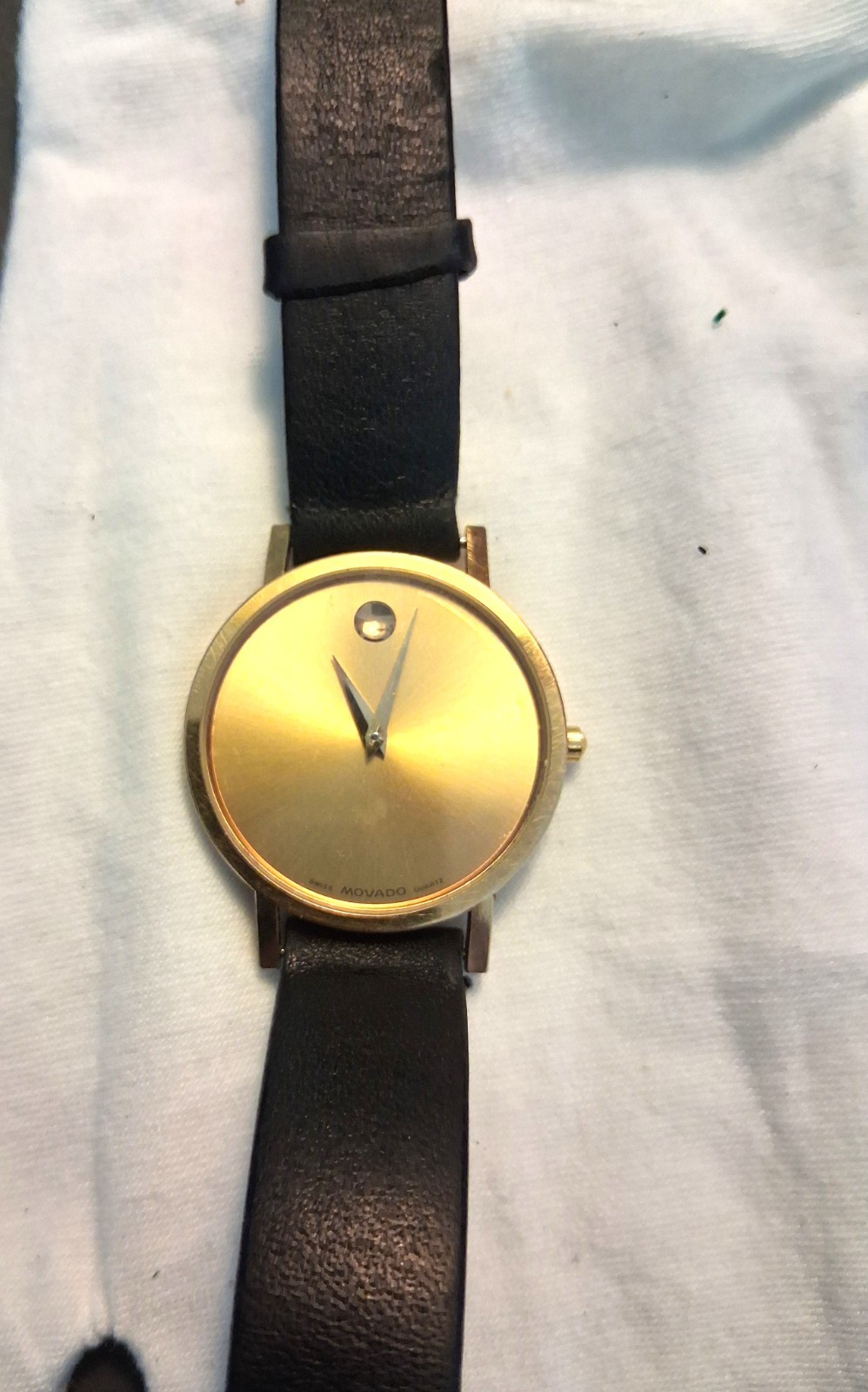 Movado Museum Wrist Watch for Men, gold face, black leather band, NEW Battery
