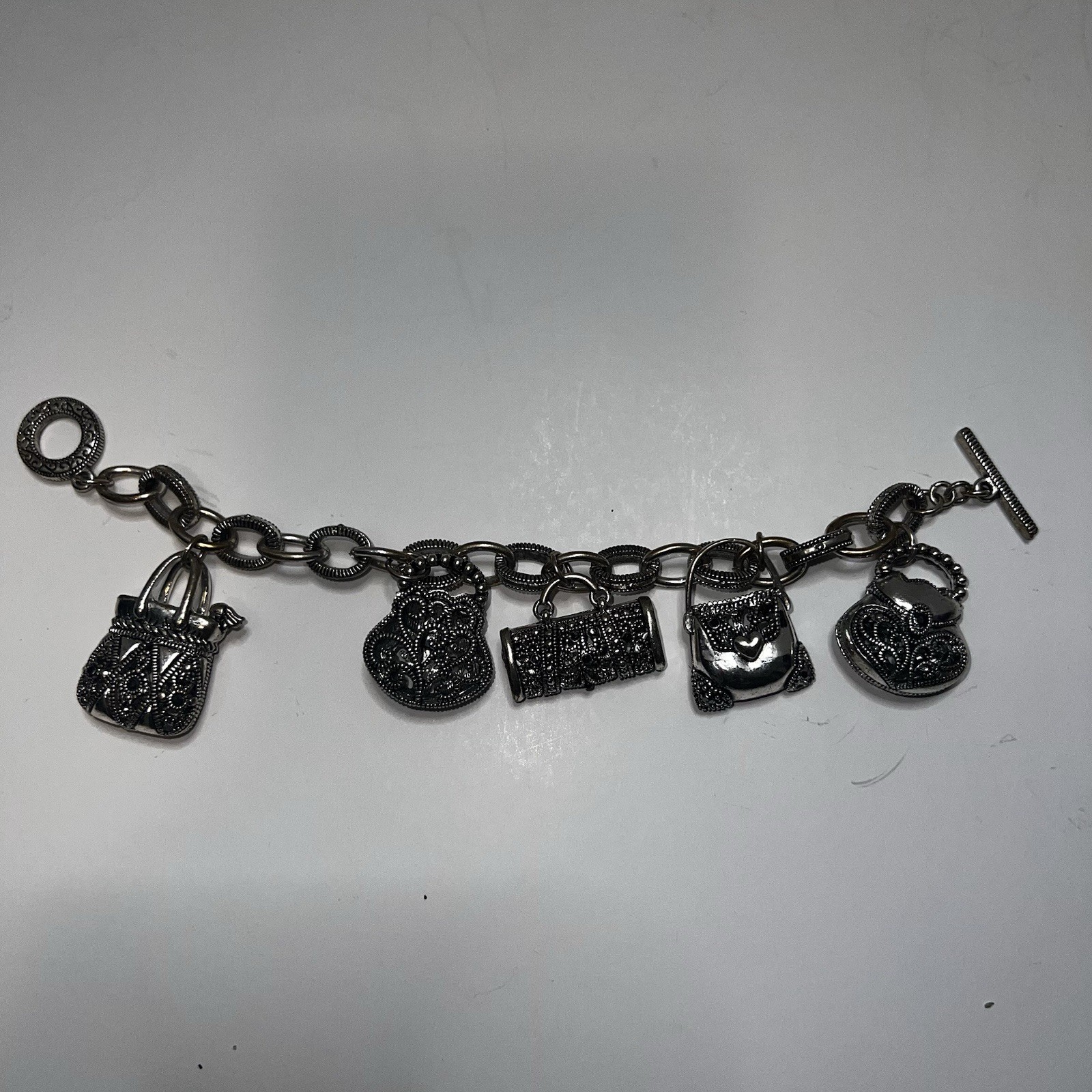 Silver-Tone Metal Puffy Openwork Purse Rhinestone Accent Charm Bracelet toggle