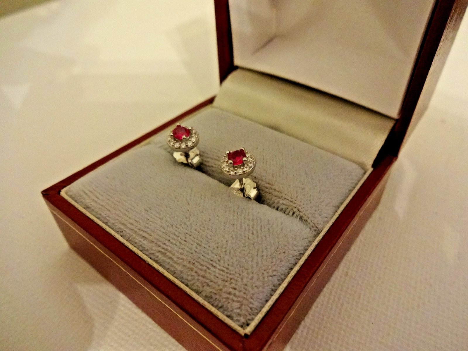 Created Ruby and diamond halo stud earrings in sterling silver