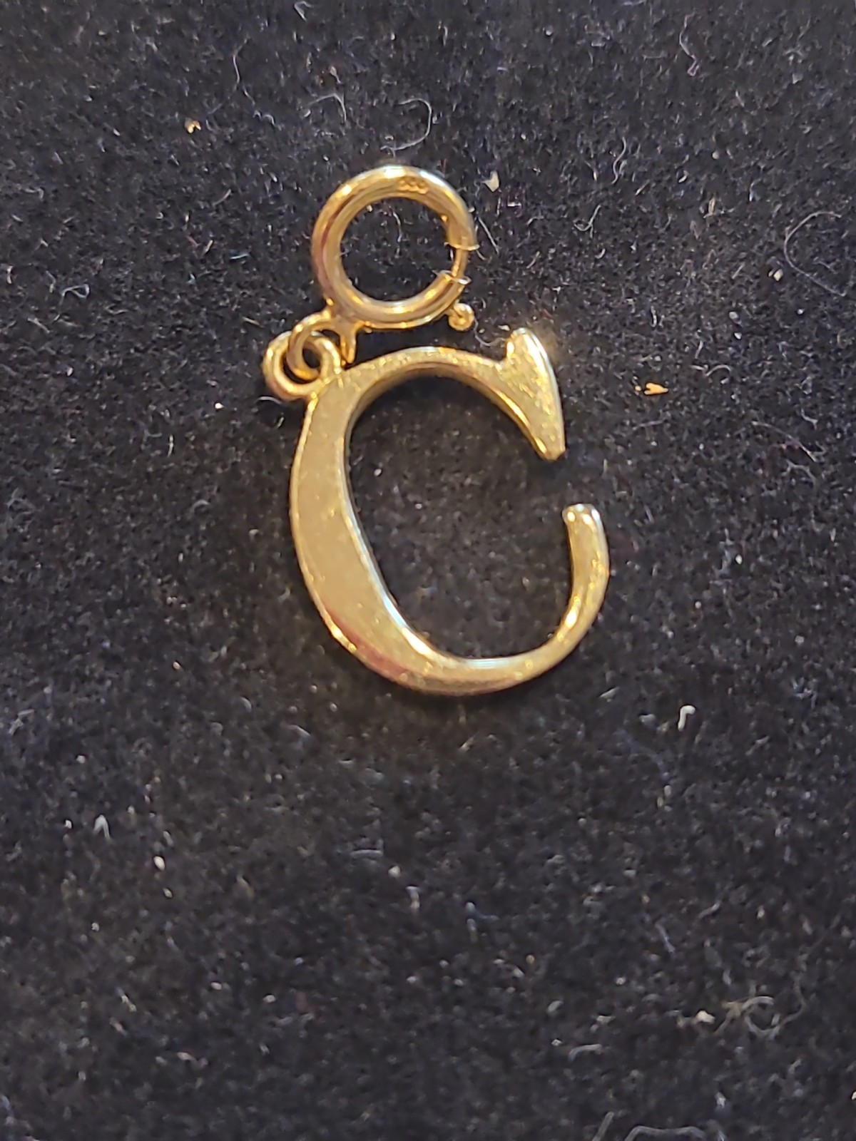 Gold charm letter C with spring closure. 14 kt gold. .61 g