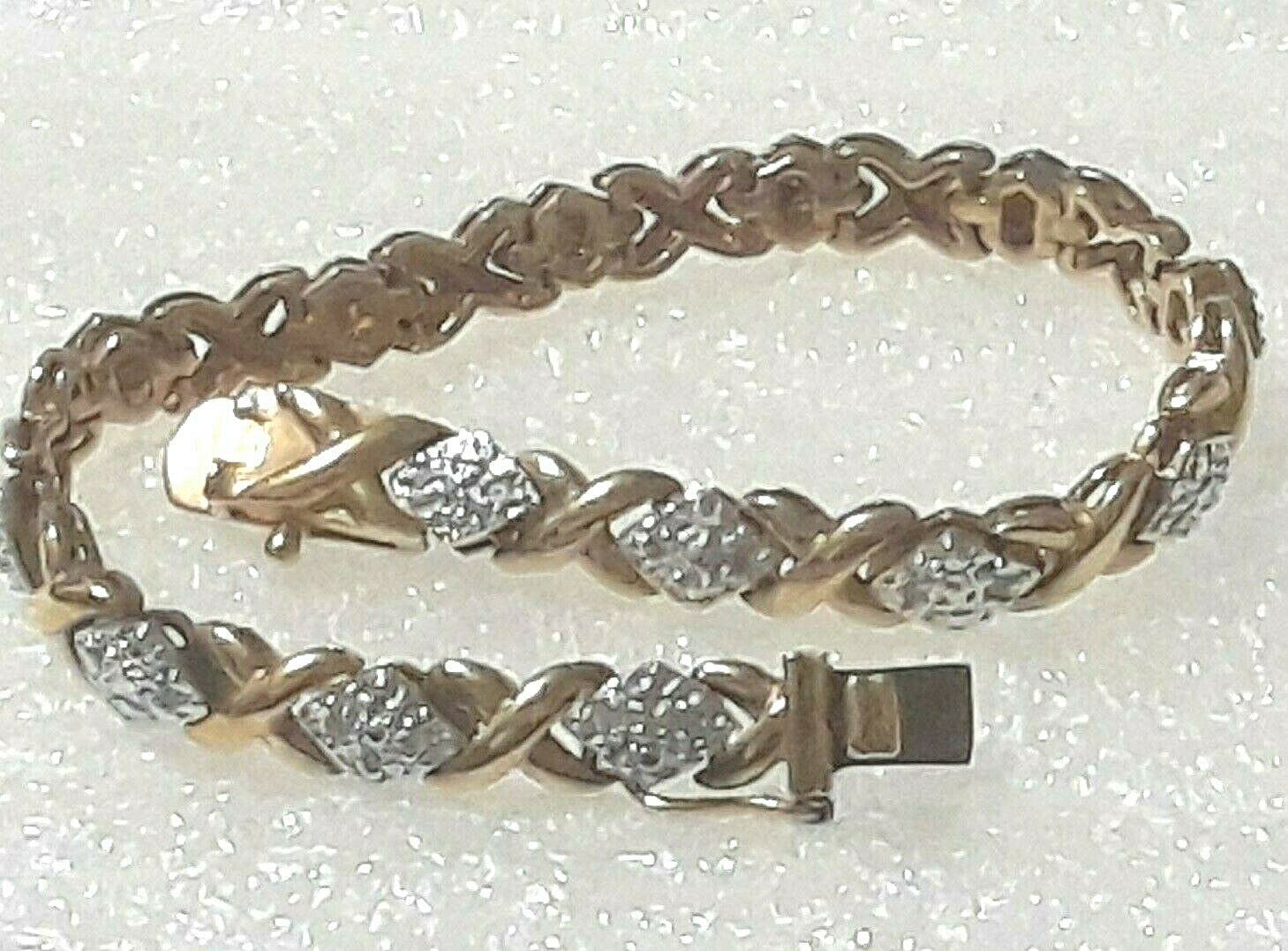 Gold tone bracelet with clear stones and safety lock clasp. 7″ long. Beautiful!