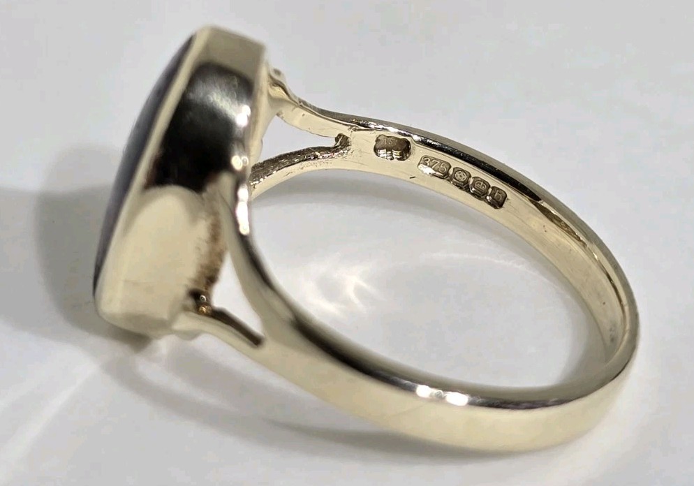 9ct Yellow gold open work ring. Collet set with an oval Blue John Cabochon.
