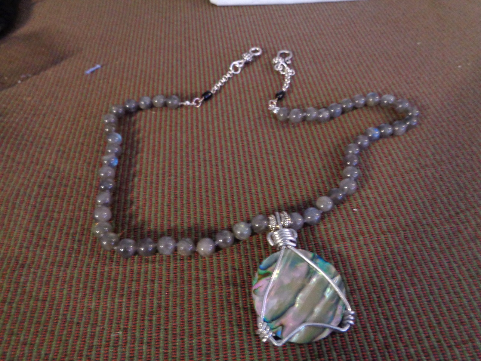 Artisan crafted, gorgeous, aluminum wrapped Paua pendant, on 19” Labradorite str