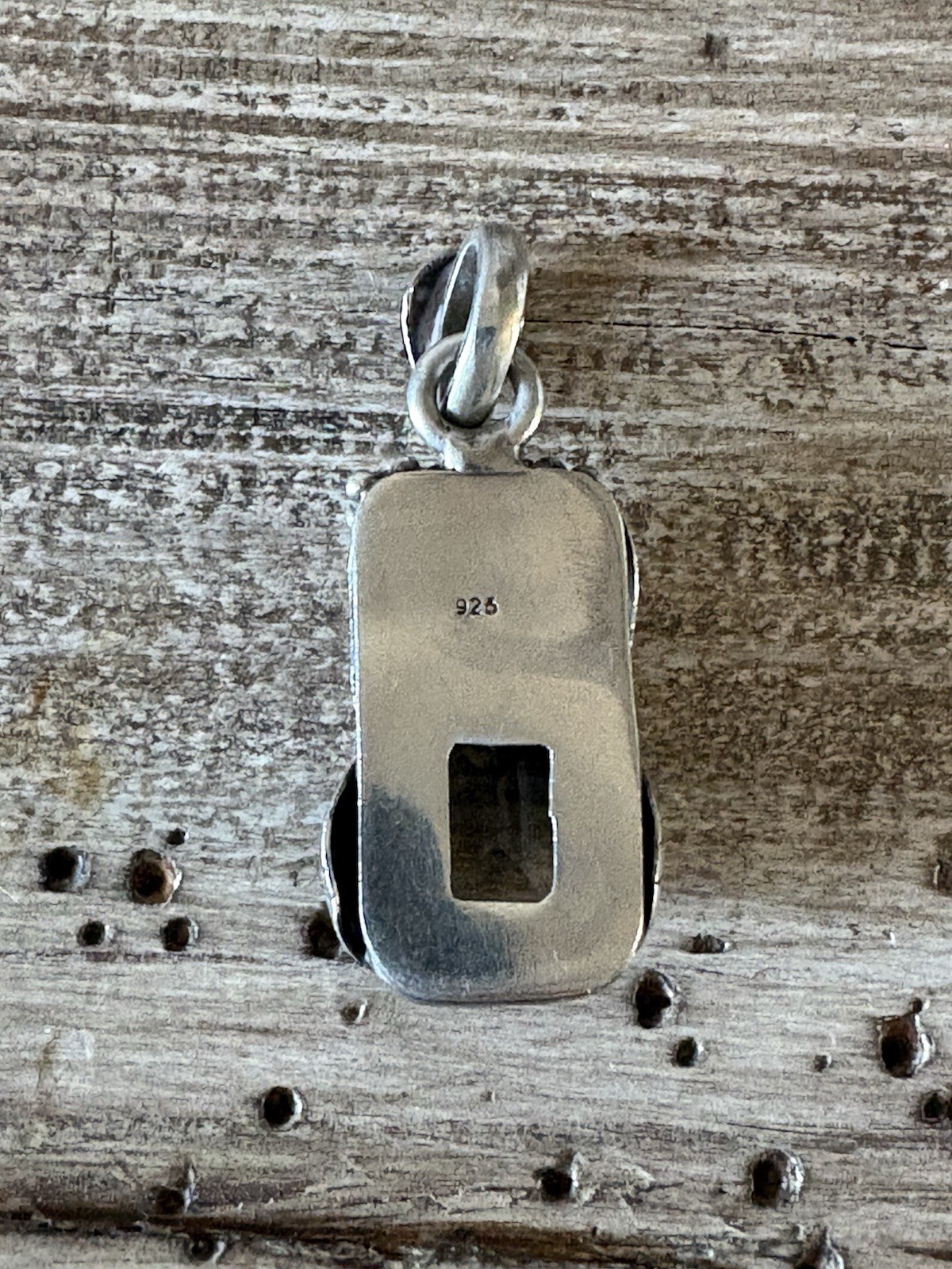 Marked 925 , stone surrounded with silver flower,leaves and berries