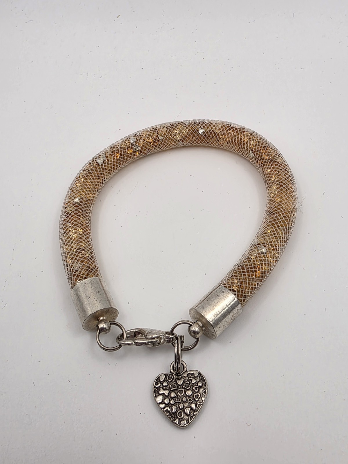 Gold Tone Tubular Mesh Bangle With Crystals And Heart Charm